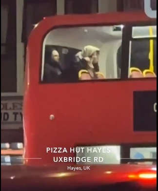 Couple celebrating New Year with intimacy on London double-decker bus